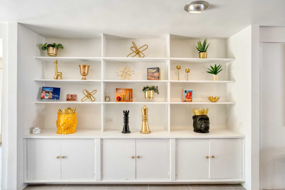 Welcome to your sanctuary of serenity! This chic living room seamlessly melds contemporary design with plush comfort, beckoning you to relax with loved ones. Cozy up for movie nights on the large flat-screen TV, nestled near the dazzling fireplace.
