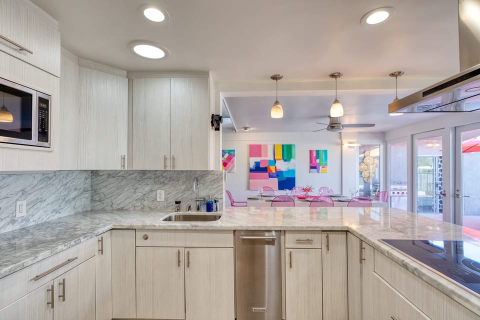 Gather around the stylish kitchen bar with seating for four. Featuring stainless steel appliances, sleek countertops, and ample cabinet space, it's the perfect space to cook and gather with family and friends, creating delicious memories together.