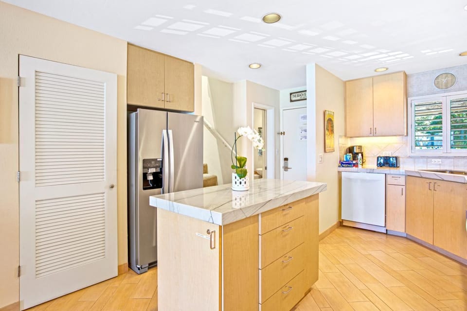 This golden-hued kitchen is a canvas of calm, where morning light, sea breeze, and simmering joy come to mingle    