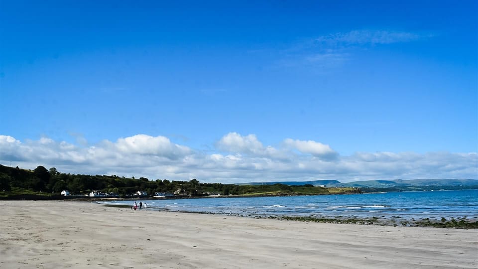 Browns bay beach with Antrim coast in background