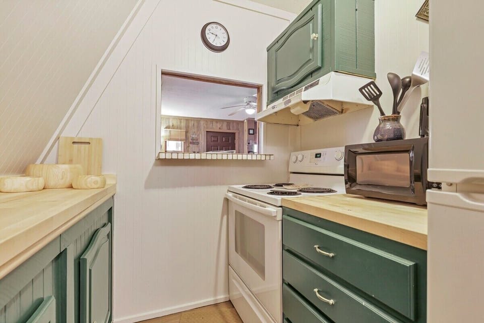 Kitchen is equipped with an electric range, microwave and a fridge