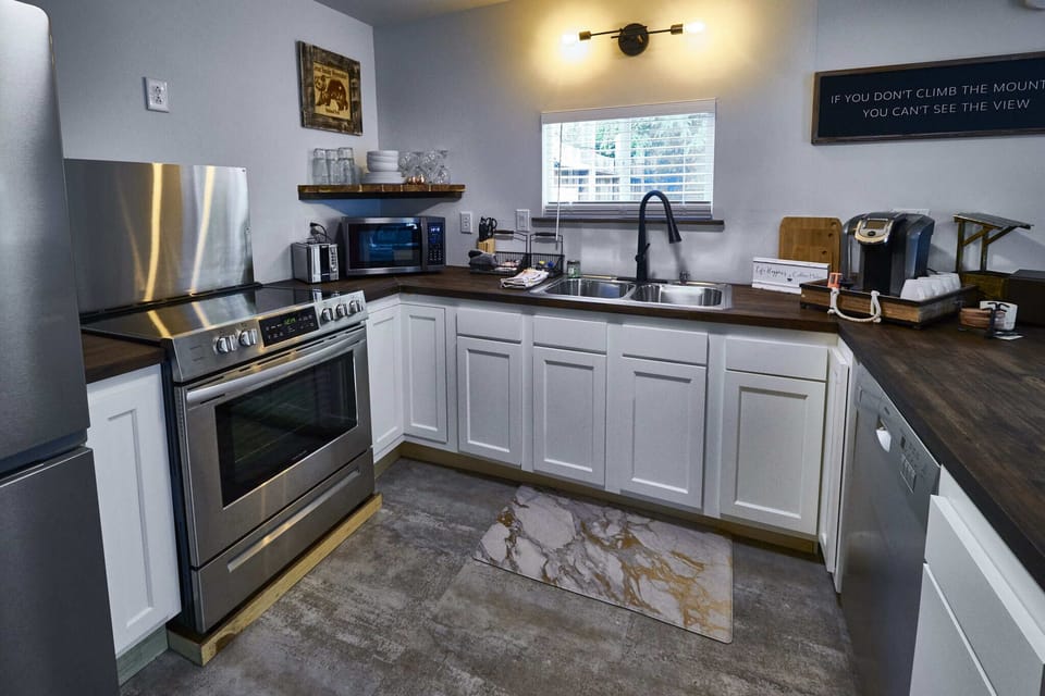 The brand new kitchen has state-of-the-art, stainless steel appliances, including a French door fridge/freezer combo, a four-burner electric range, oven, microwave, dishwasher, Keurig coffee maker, toaster, and large double-basin stainless steel sink with