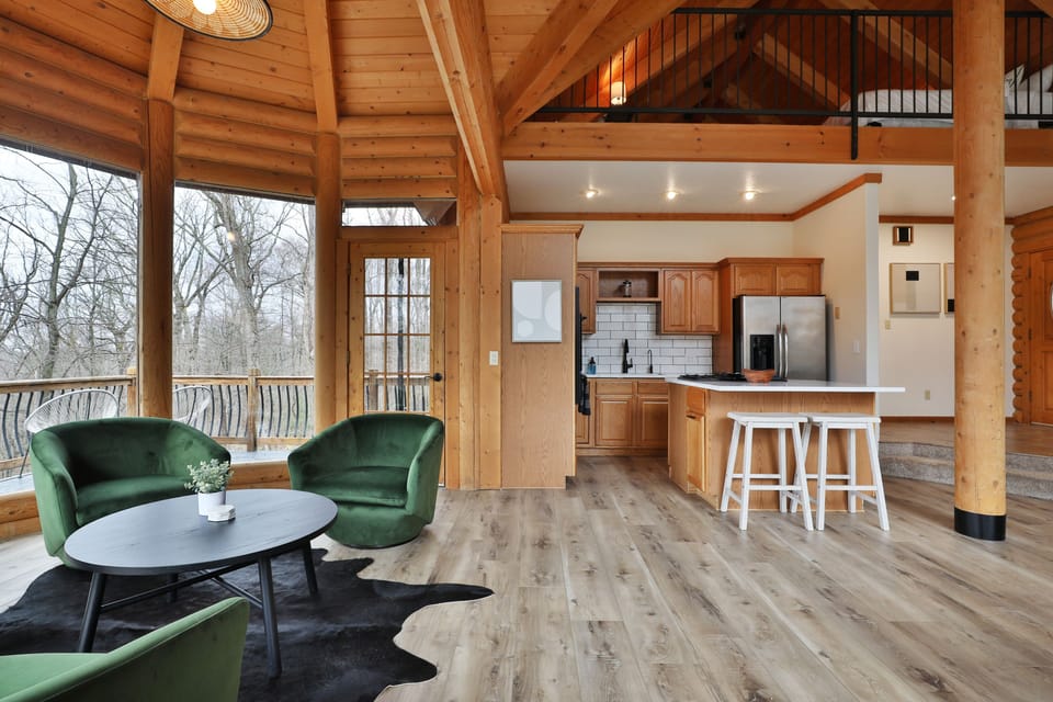 First Floor living area. Couches, chairs, a full kitchen, walkout deck and views