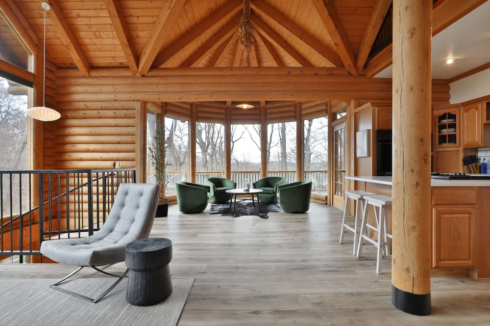 First Floor living area. Couches, chairs, a full kitchen, walkout deck and views