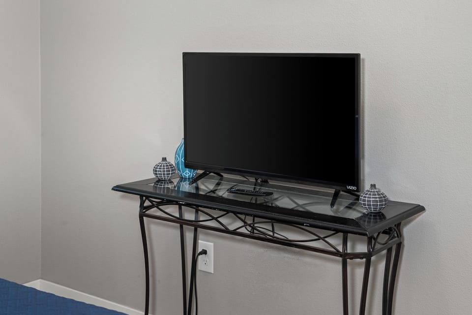 Flat-screen TV with sleek console for easy in-room entertainment