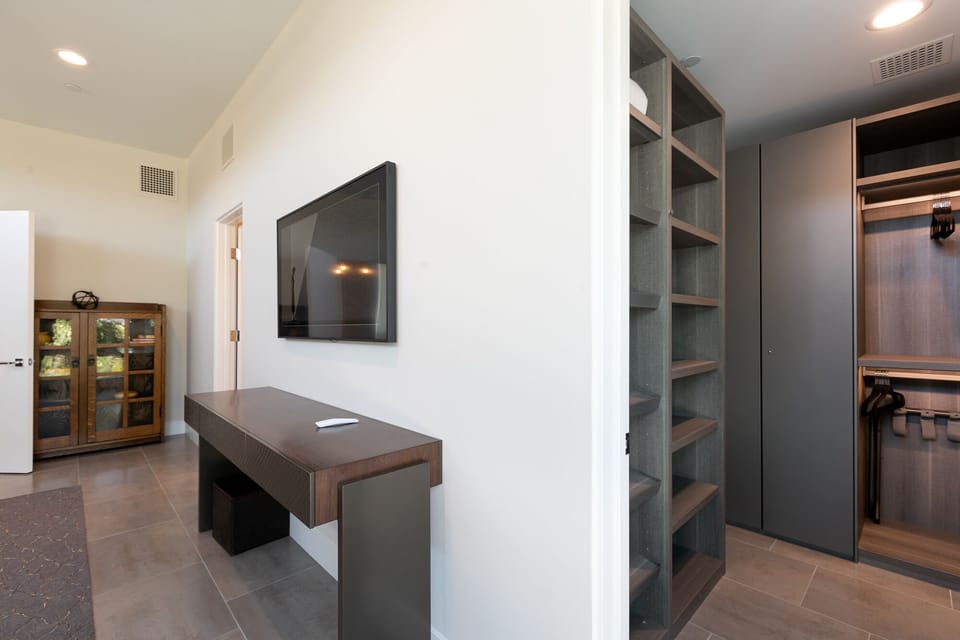 Television and walk in closet of the Valley Bedroom. 