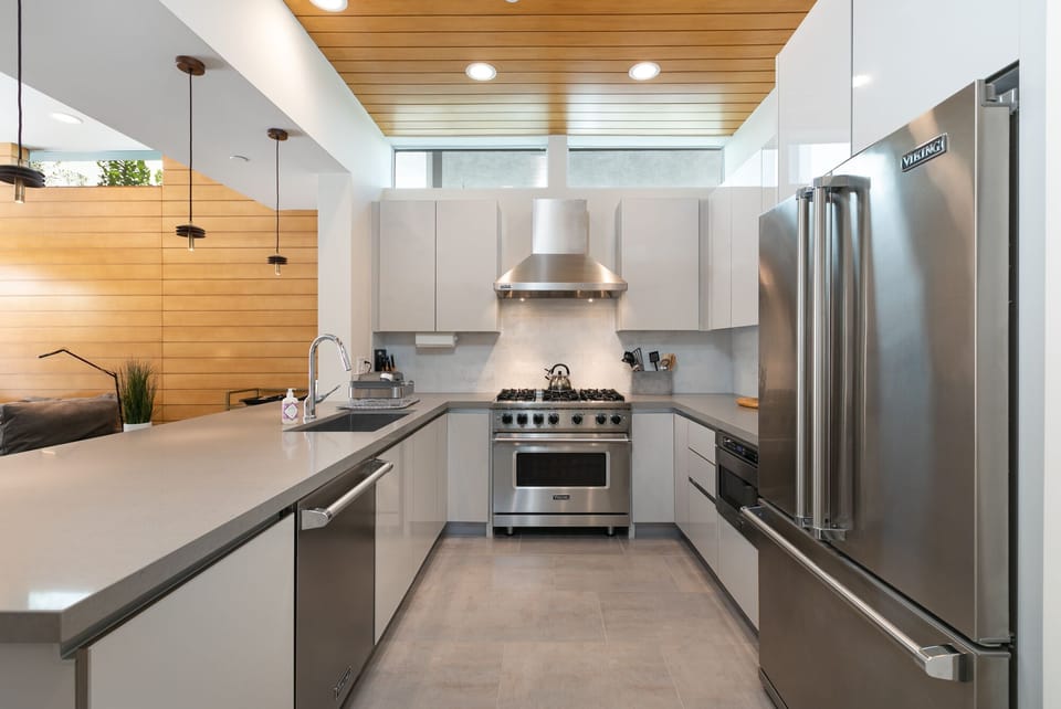 Upscale Viking appliances include fridge, gas stove, micro and dishwasher. 