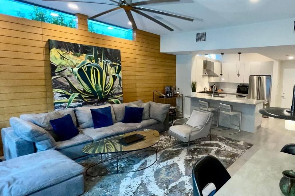 Great room with view to the kitchen.  Includes upscale designer furniture.  
