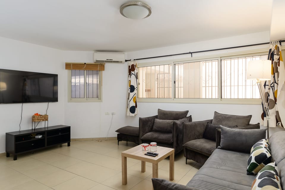 Living room area with TV and sofas