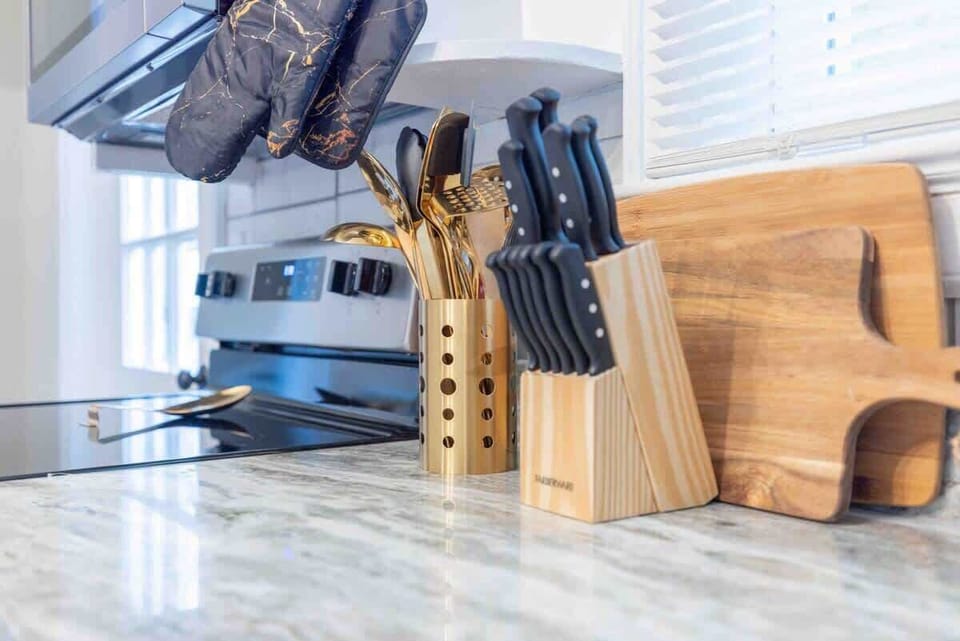 Fully stocked kitchen with gold cooking and eating utensils! 