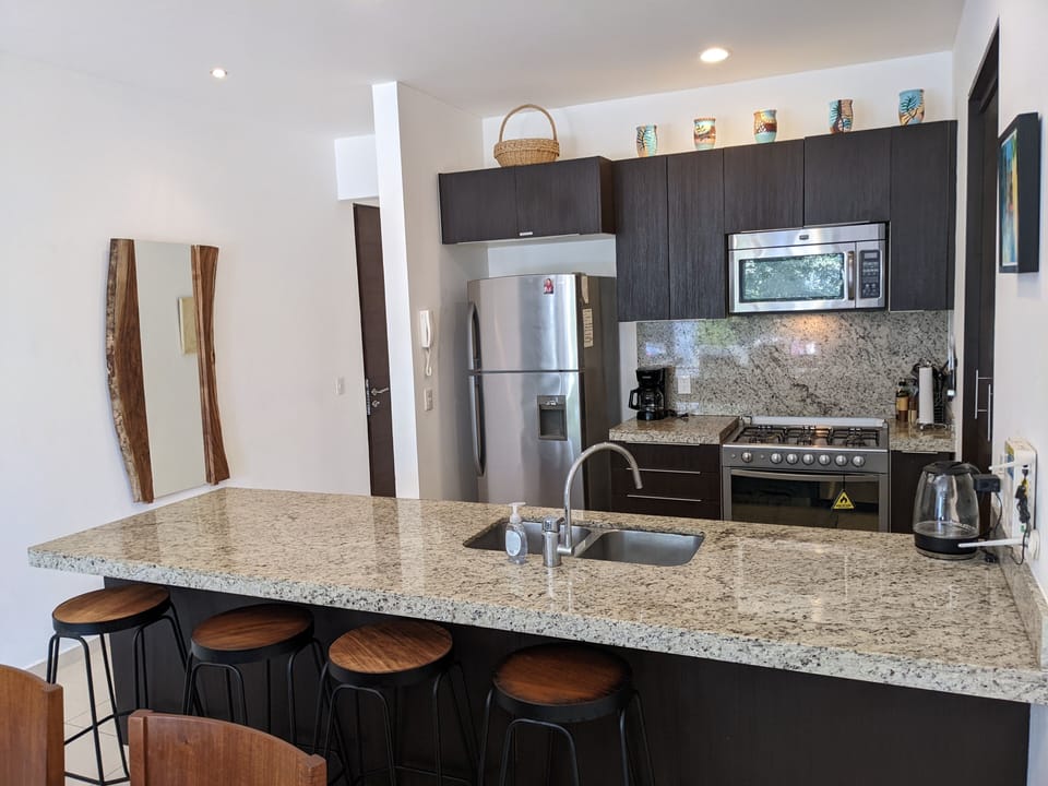 Granite counters, washer, dryer, stove, coffee maker, microwave.