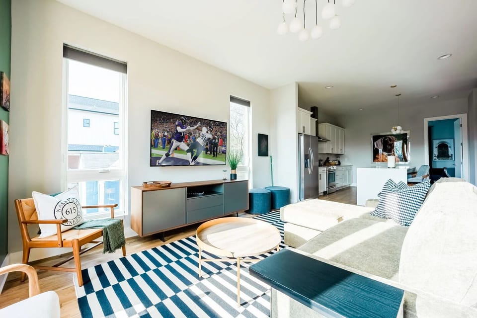 Naturally bright and open living area with smart TV.