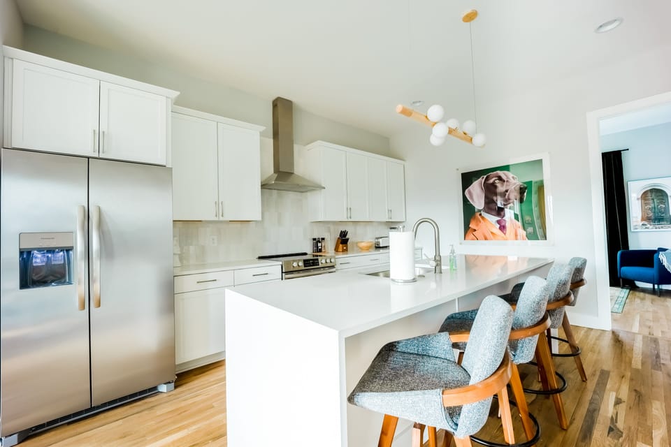 Bright and open fully equipped kitchen with stainless steel appliances. Complete with breakfast bar seating.