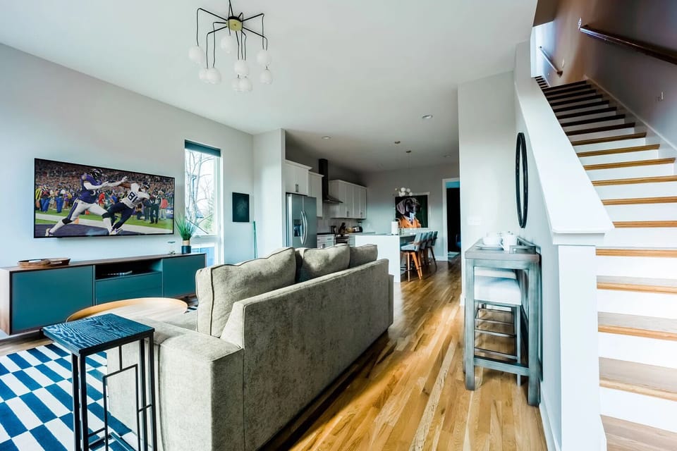 Naturally bright and open living area with smart TV.