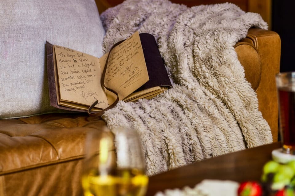 Living Room: Indulge in mountain views and warm memories by the fireplace with our guestbook!