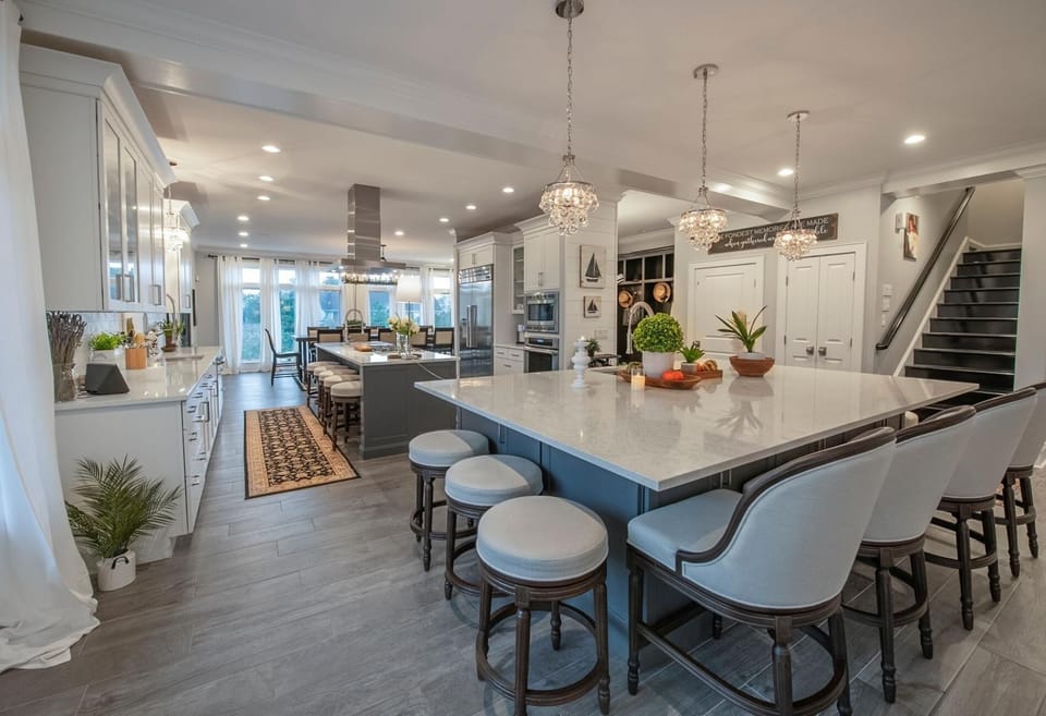 The 2nd-floor chef's kitchen features a large island with a built-in sink, beverage fridge, and plenty of seating—ideal for cooking, entertaining, and gathering.