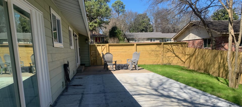Privacy fence with fire pit, grill, and outdoor games