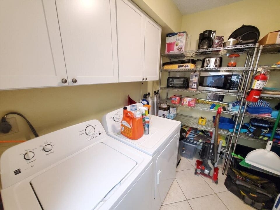 Convenient in-house laundry room with ample storage and supplies.