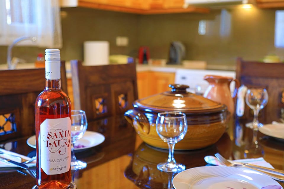 Dining table with wine%2C glasses and Crockpot