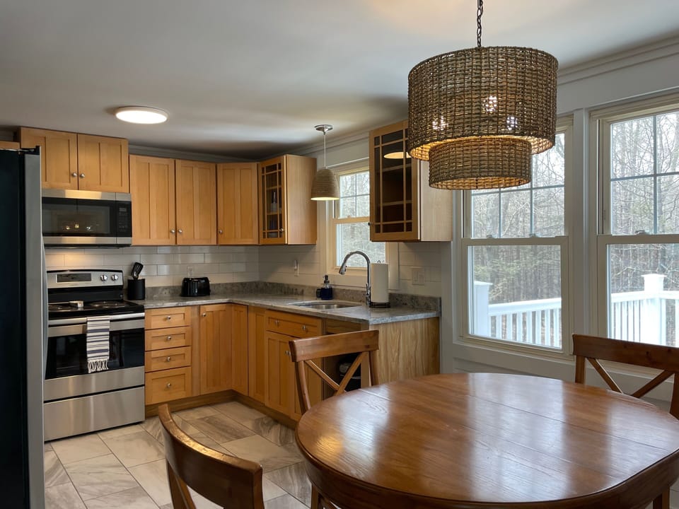Kitchen, includes refrigerator, electric stove, dishwasher and coffee makers.
