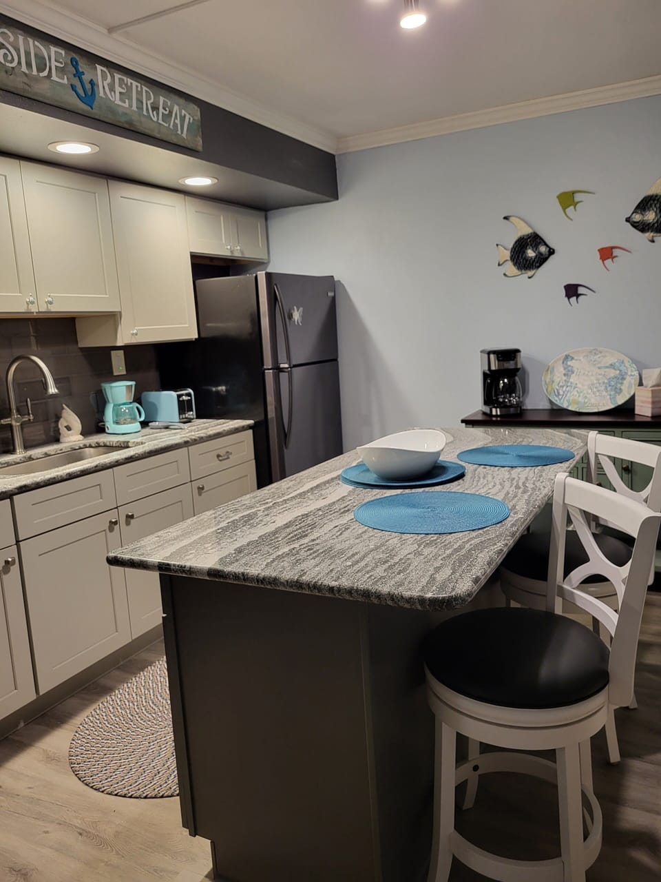 Stylish kitchen with quartz counters and island.  Comfy swivel bar stools.