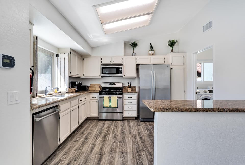 Kitchen has all stainless appliances with dishwasher, stove, microwave, fridge.