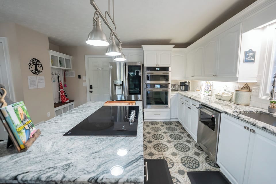Large open kitchen on main level, with glass top stove