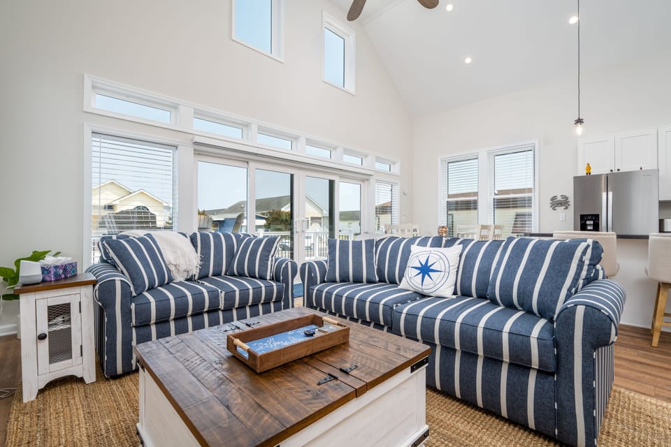 Main living area/kitchen, beautiful large windows & sliding glass doors to deck