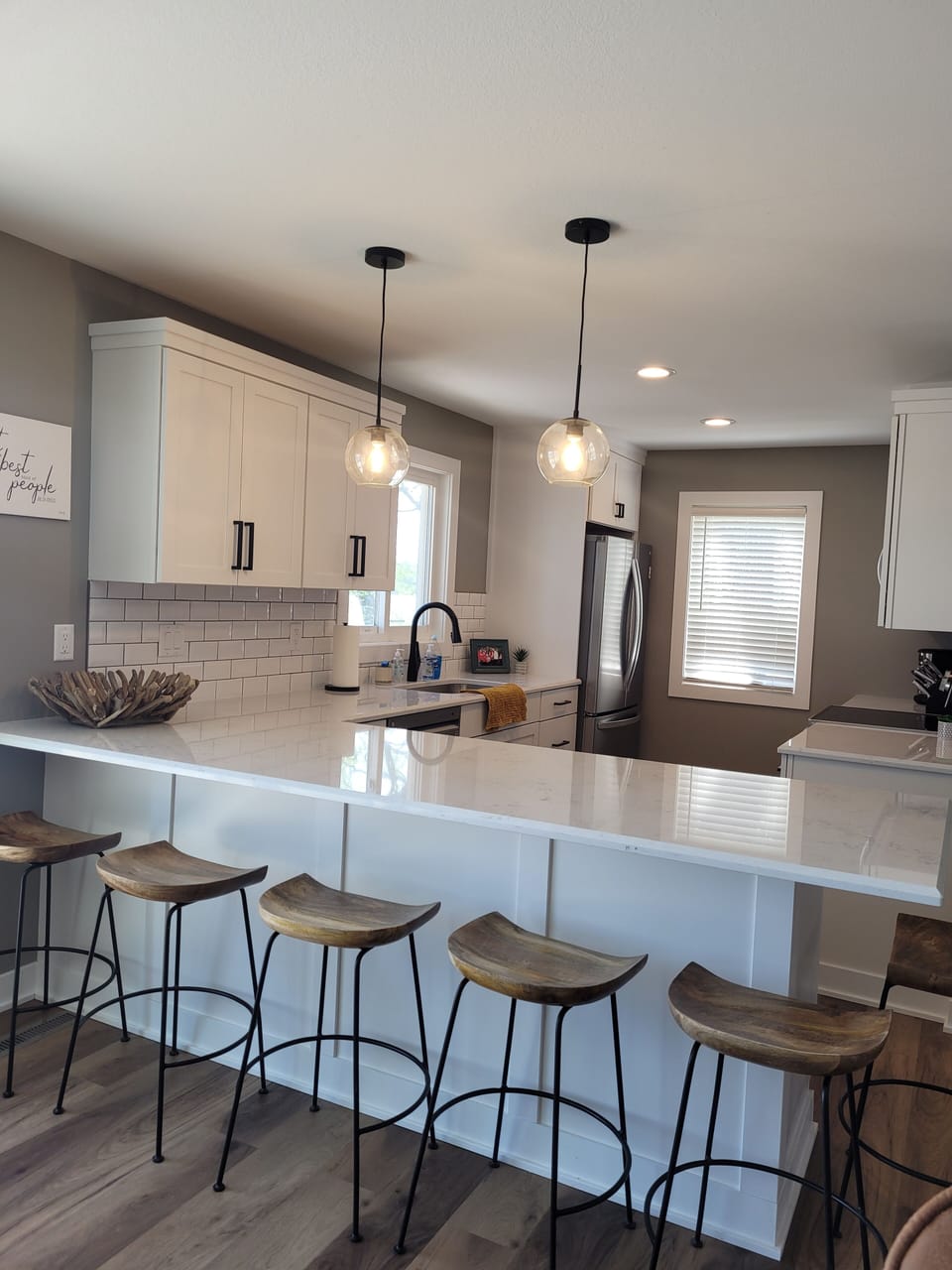 Fully stocked kitchen with range, microwave, dishwasher, and fridge.