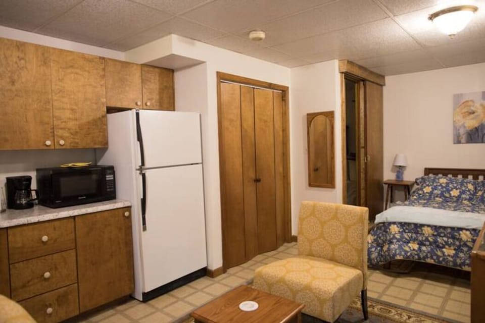 Double closet with hangars, dehumidifier, laundry bag, broom, vacuum.