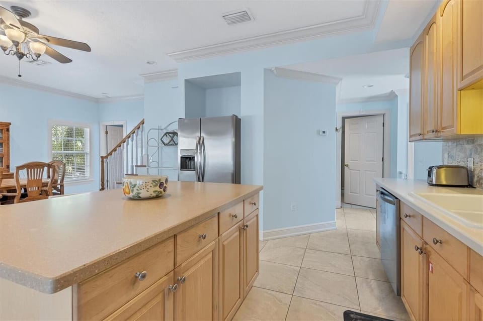 Kitchen island and counter with open views to the dining area