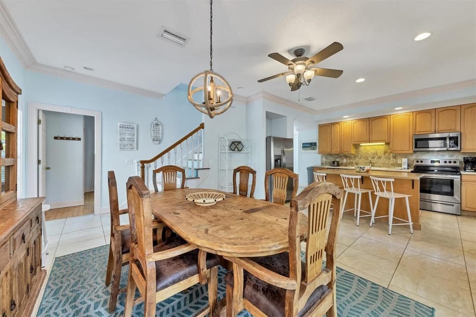 Open-plan living and dining area with kitchen visible in the background