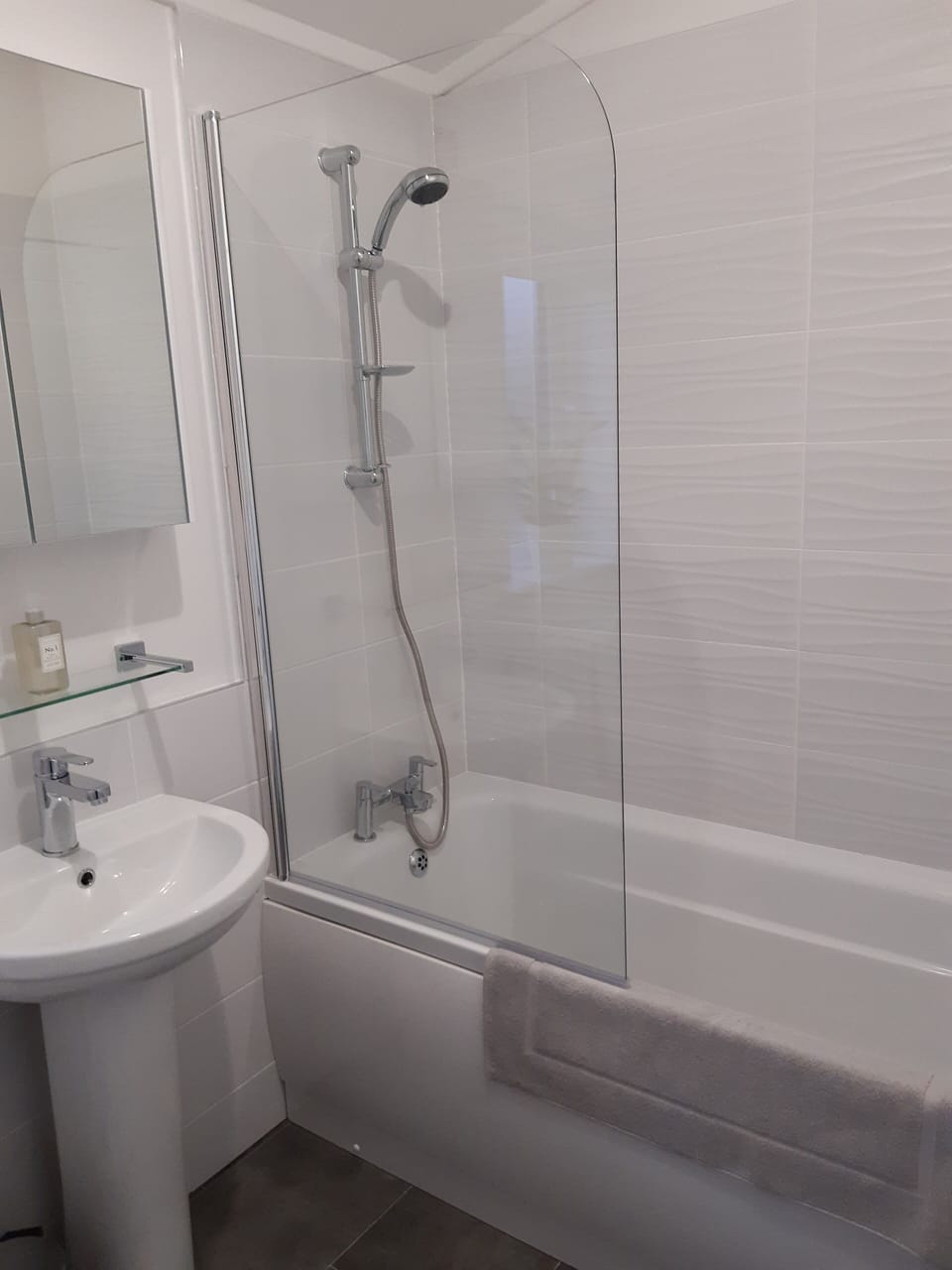 Main bathroom with shower over the bath.