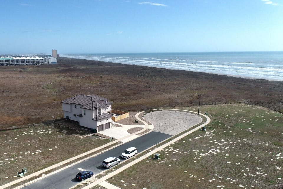 Stunning coastal property with direct beach access and panoramic ocean views in a pristine natural setting.