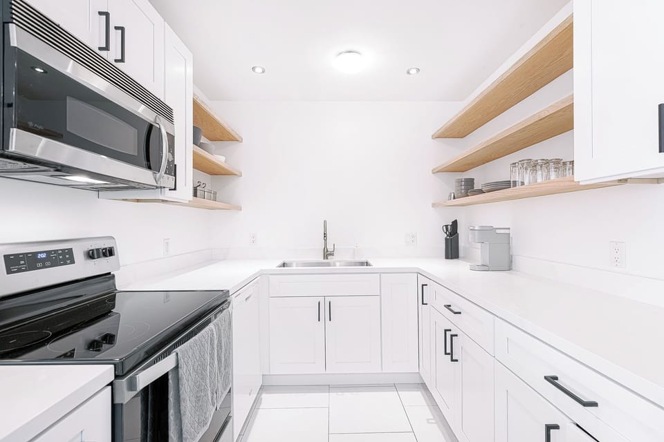 Cook with ease in our well-lit kitchen, featuring abundant cabinet space.