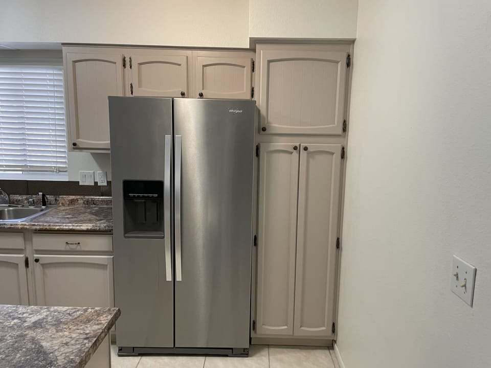 large refrigerator w/large freezer and ice maker.