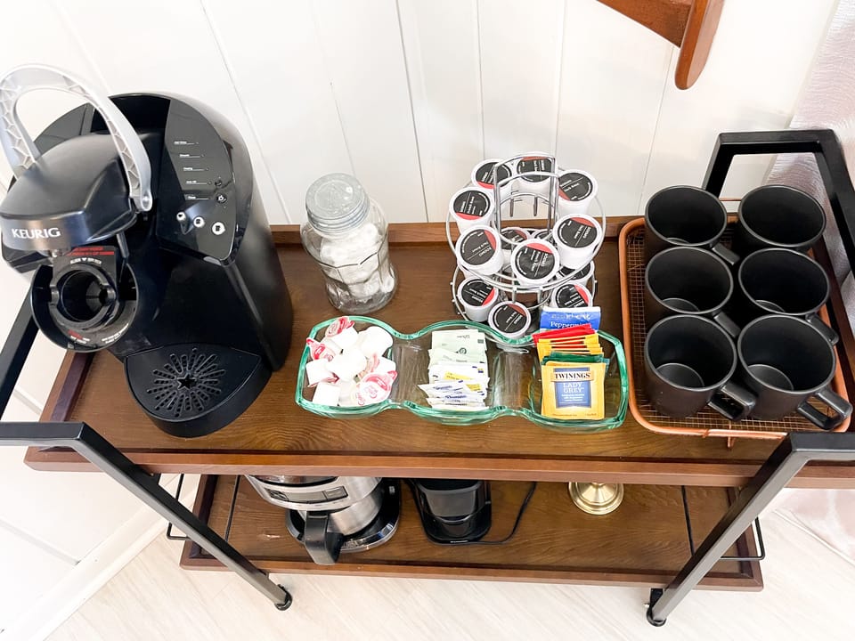 Coffee bar with keurig, pods, cream, sugar, tea, and mints. 
Drip coffee maker
