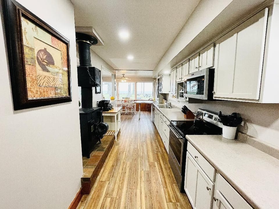 Spacious, fully stocked kitchen with ample counter space, modern appliances, and all the essentials you need to cook and dine. Perfect for preparing family meals or entertaining large groups during your stay.