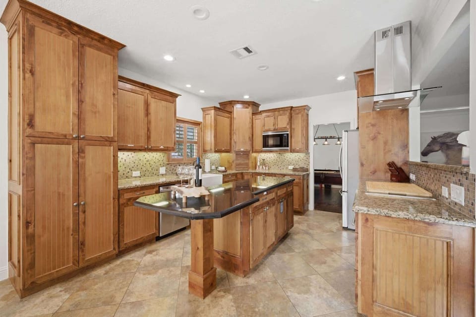 Fully stocked kitchen with stainless stell pots and pans, cutting boards etc