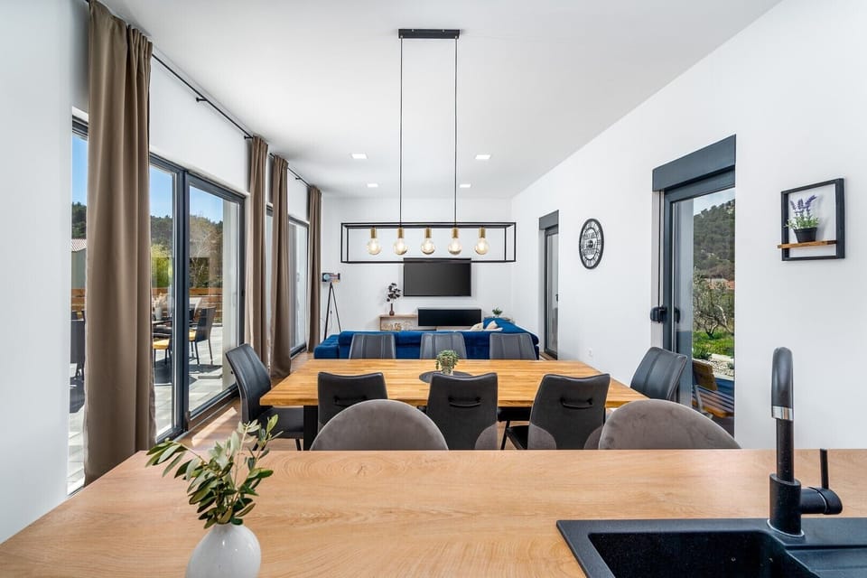 Dinning and living area with sliding glass doors toward the pool area