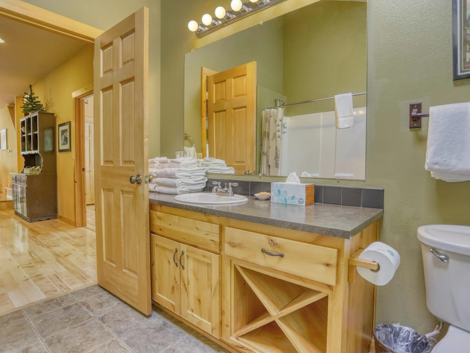Refresh in your private bathroom with warm wood cabinetry, plush white towels, and plenty of counter space for all your essentials.