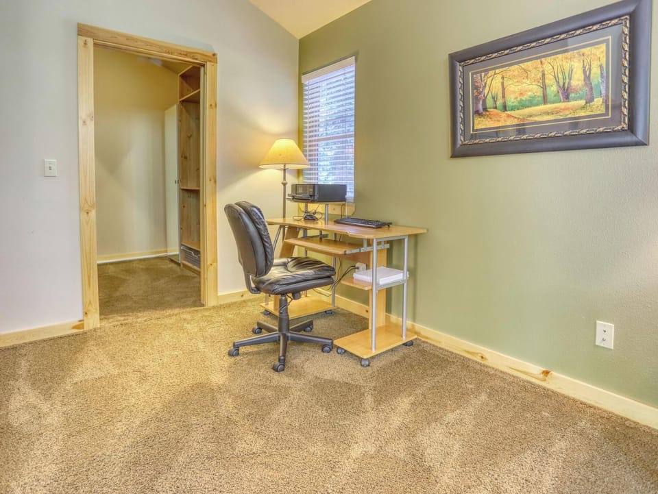 Your dedicated workspace with natural light and peaceful autumn artwork creates the perfect spot to catch up on emails or plan your next adventure.