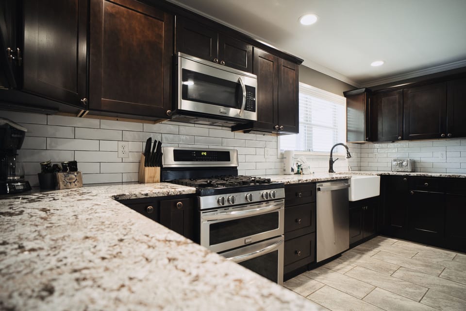 Kitchen with stainless steel appliances, farm sink, and cooking essentials.