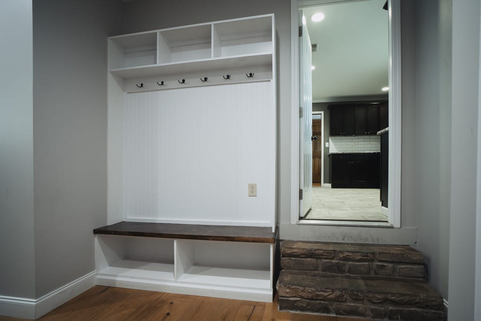 Mud room with places for bags and shoes. 