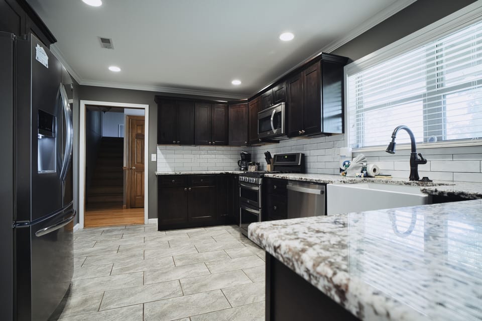 Kitchen with stainless steel appliances, farm sink, and cooking essentials.