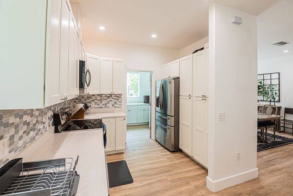 Fully stocked kitchen with access to laundry room area