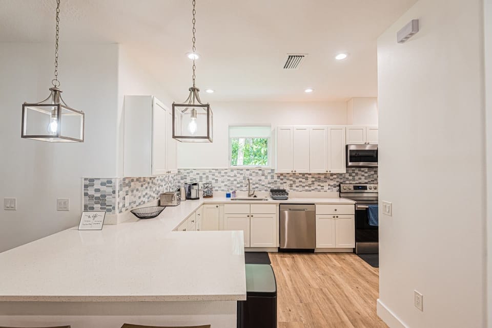 Kitchen with plenty of counter surface and bar stool area