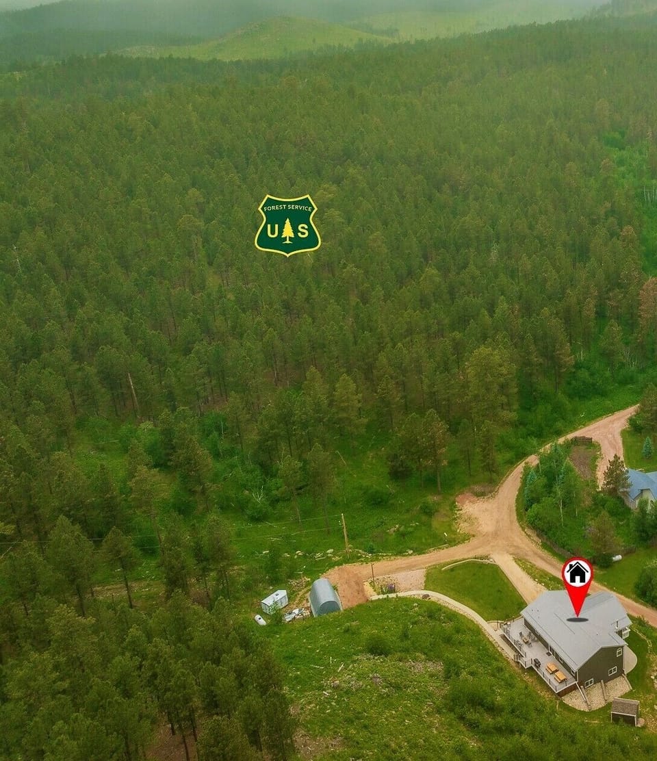 Home surrounded by Black Hills National Forest. Gate to trails around the bend.