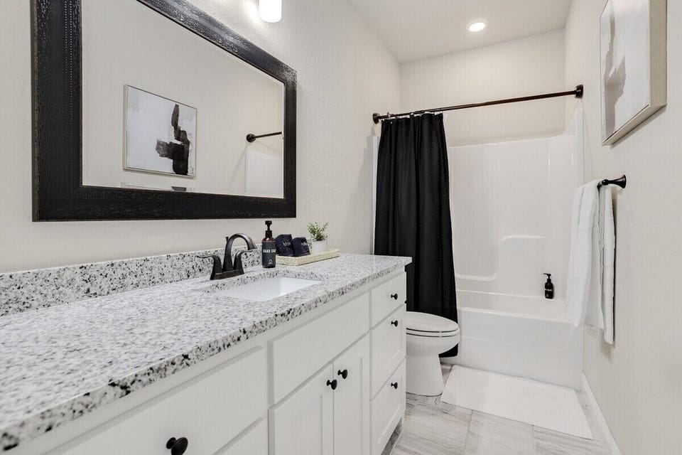 Our second bathroom has a single sink, combination tub/shower and TONS of counter space.