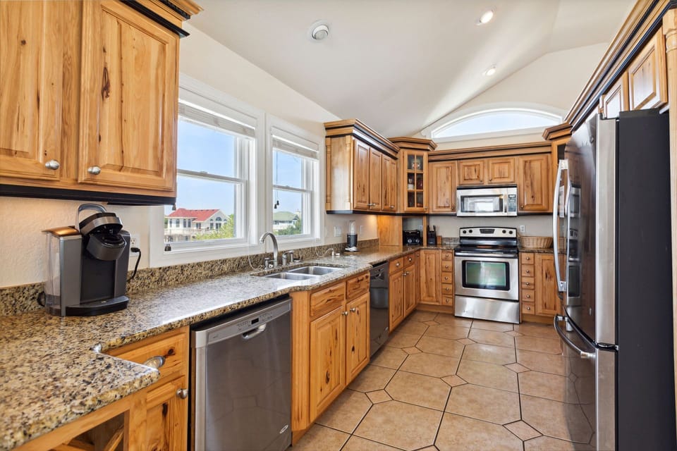 Whip up a delicious meal in the Modern Kitchen with stainless steel appliances, 2 Refrigerators, 2 Dishwashers, 2 Microwave Ovens, a Range, and a Wine Cooler.